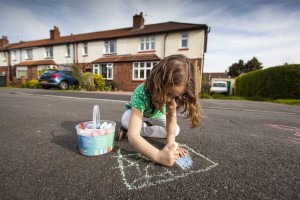 Girl chalking on street