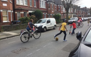 Cycling and football in the street
