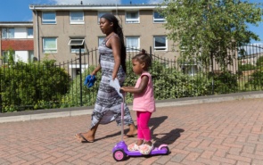 Parent and child playing out on housing estate