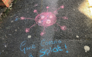 Chalk drawing saying give corona a splat