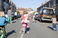 children cycling and scooting in road