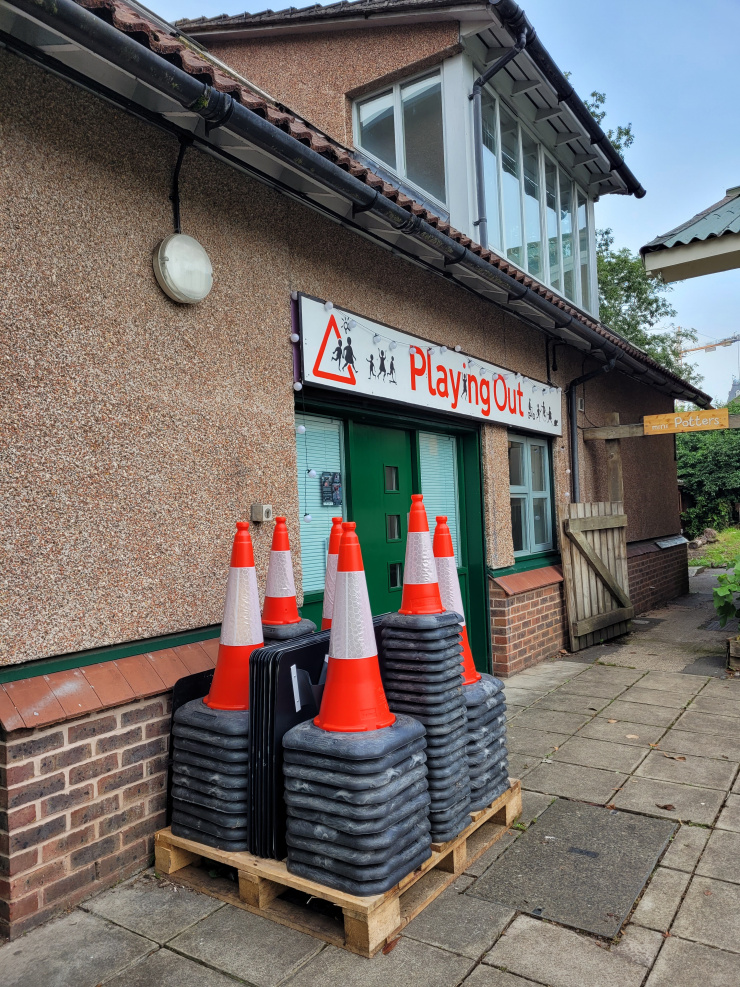 Photo of exterior of Playing Out office with traffic cones piled up outside