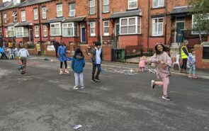 A residential street full of children playing