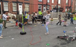 Children of different ages playing in a residential street