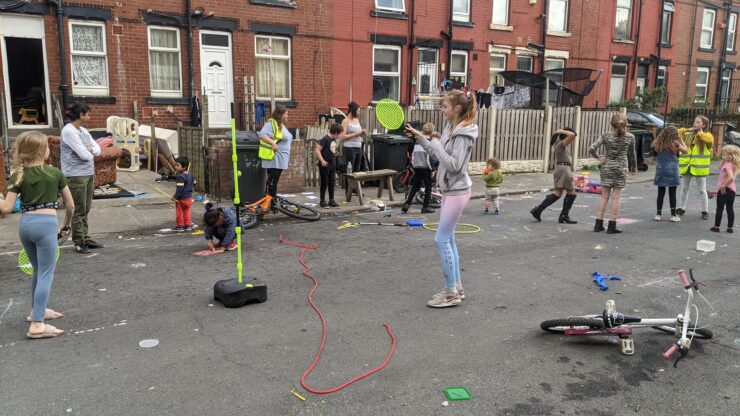 Play street Children of different ages playing in a residential street