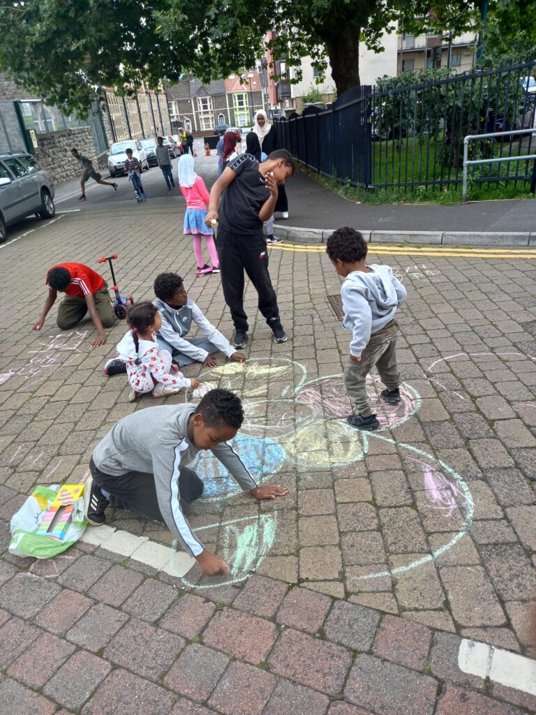 group of children playing and chalking in street